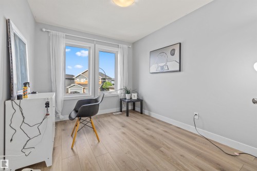 Bright interior space featuring light wood-finish flooring and neutral gray walls - 607 40 Street, Edmonton, AB 