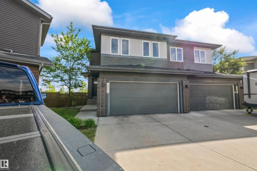 Contemporary exterior with mixed material siding, dual garage doors, and a concrete driveway - 607 40 Street, Edmonton, AB 
