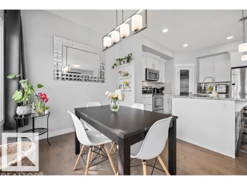 Open-concept dining area with wood-finish flooring - 607 40 Street, Edmonton, AB 