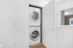 This property features a convenient laundry area with a stacked washer and dryer, situated within a dedicated alcove - 