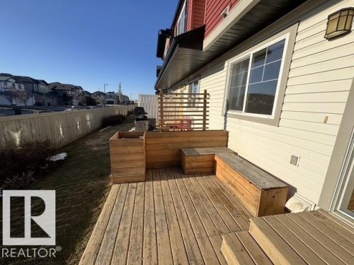 Expansive wood deck featuring built-in bench seating and a wood planter - #13 3751 12 Street, Edmonton, AB 