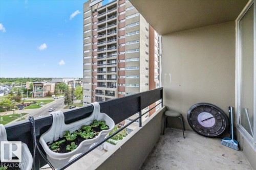 Private balcony featuring a concrete floor, a solid exterior wall, and a black metal railing - 77 8735 165 Street, Edmonton, AB 