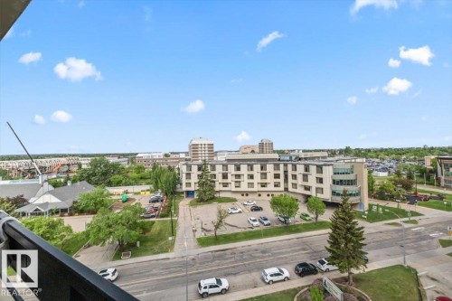 Expansive urban panorama from a high-level balcony, featuring a black metal railing - 77 8735 165 Street, Edmonton, AB 