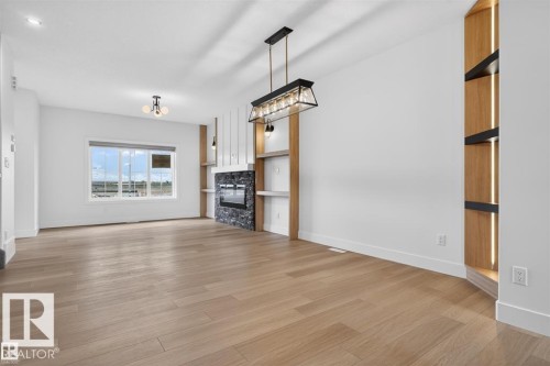 Open concept living area with wood-finish flooring - 41 River Birch Way, St. Albert, AB 