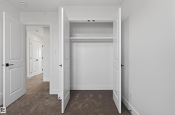 Closet featuring double bifold doors, integrated shelving, and a clothing rod - 