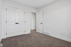 Neutral-toned carpeting complements bright white walls and trim - 