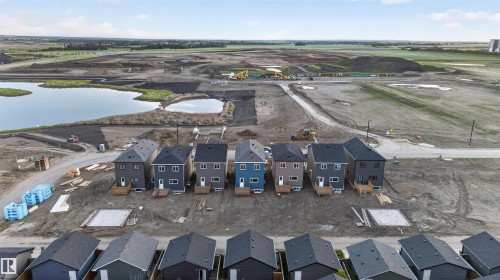 New construction homes featuring multi-color siding and dark shingle roofs - 41 River Birch Way, St. Albert, AB - Outdoor With View