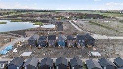 New construction homes featuring multi-color siding and dark shingle roofs - 