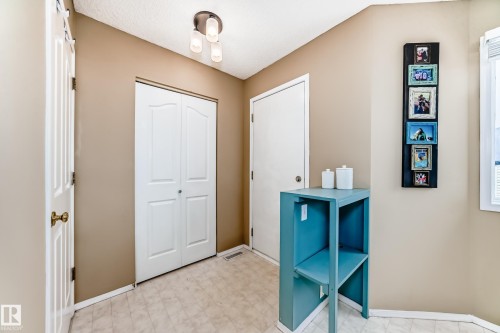 Utility space featuring neutral wall tones, bi-fold closet doors, and recessed lighting - 11831 9 Avenue, Edmonton, AB 