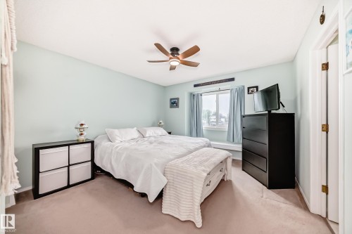 Bedroom featuring light blue walls and neutral carpet flooring - 11831 9 Avenue, Edmonton, AB 