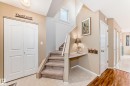 Carpeted staircase with white railing, built-in desk niche, and overhead window - 11831 9 Avenue, Edmonton, AB 