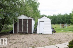 Two storage sheds featuring gabled roofs and vertical siding - 