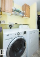 Dedicated laundry area featuring a front-loading washing machine and a separate dryer - 