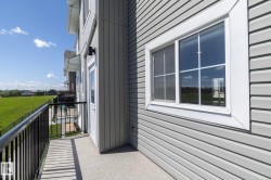 Private balcony featuring concrete flooring and black metal railings - 