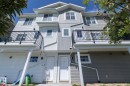 Multi-level townhouse exterior featuring light gray and white horizontal siding - 2610 Maple Way, Edmonton, AB 