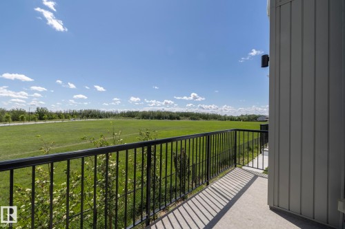 Exterior balcony featuring a concrete surface and black metal railings - 2610 Maple Way, Edmonton, AB 