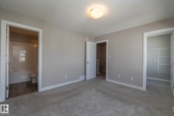 Neutral-toned interior featuring plush gray carpeting and white trim - 