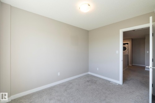 Carpeted room with light gray walls and white trim - 2610 Maple Way, Edmonton, AB 