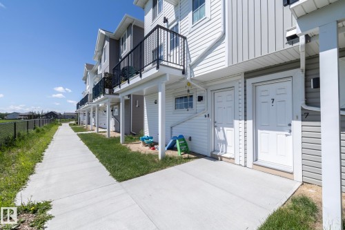 Row of multi-level properties with horizontal and vertical siding - 2610 Maple Way, Edmonton, AB 