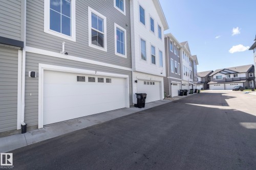 Attached white garage door with upper window inserts - 2610 Maple Way, Edmonton, AB 