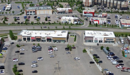 Aerial perspective of a commercial district featuring multiple retail buildings with dedicated parking areas - 2610 Maple Way, Edmonton, AB 