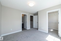 Carpeted room with light gray walls, white trim, and a semi-flush mount ceiling light - 