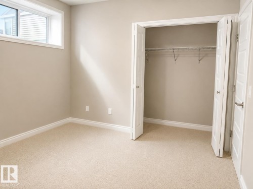 Neutral-toned walls complement the light-colored carpeting - 7274 Morgan Road, Edmonton, AB 