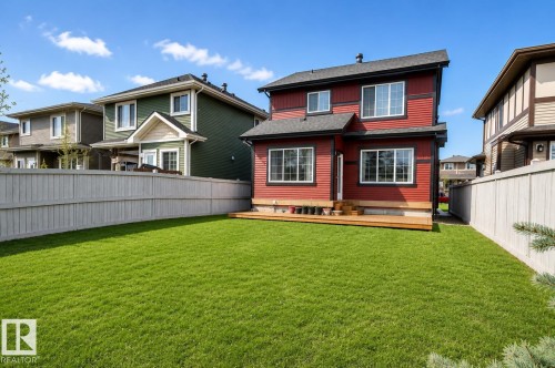 Expansive rear lawn featuring a low-profile wood-finish deck - 7274 Morgan Road, Edmonton, AB 