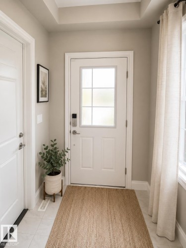 Entryway featuring a white paneled door with frosted glass inserts, a smart lock system, and light-colored tile flooring - 7274 Morgan Road, Edmonton, AB 