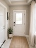 Entryway featuring a white paneled door with frosted glass inserts, a smart lock system, and light-colored tile flooring - 7274 Morgan Road, Edmonton, AB 
