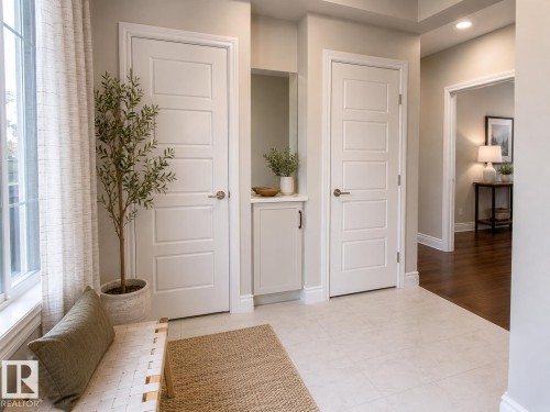 Entryway featuring light tile flooring, white baseboards, and two paneled interior doors - 7274 Morgan Road, Edmonton, AB 