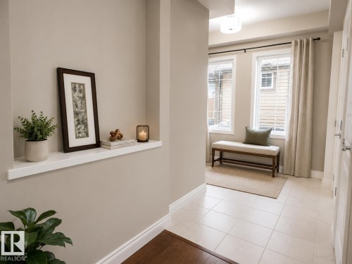 Entryway featuring tile flooring, a built-in wall niche, and two windows providing natural illumination - 7274 Morgan Road, Edmonton, AB 