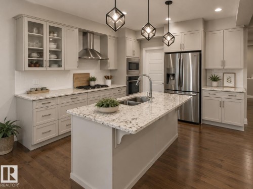 Kitchen featuring an expansive island with an undermount double-basin sink, light-toned cabinetry, stainless steel appliances, and wood-finish flooring - 7274 Morgan Road, Edmonton, AB 