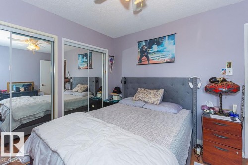 Interior space featuring wood-finish flooring and a light purple wall color - 6 3819 76 Street, Edmonton, AB 