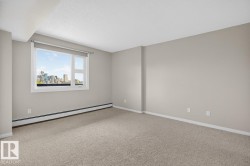Room featuring light beige wall paint, textured ceiling, and light-colored carpet flooring - 