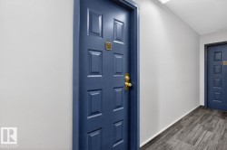 Entry door with a paneled design and brass hardware - 