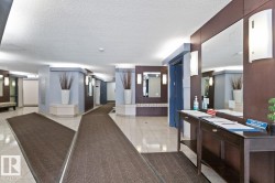 Spacious entryway featuring light tile flooring and dark accent rugs - 