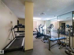 Dedicated fitness space featuring wall-to-wall carpeting and full-length mirrors - 