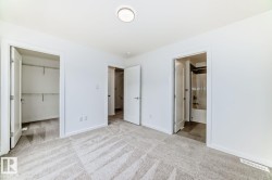 Neutral-toned carpeting spanning the room, complemented by white walls and trim - 