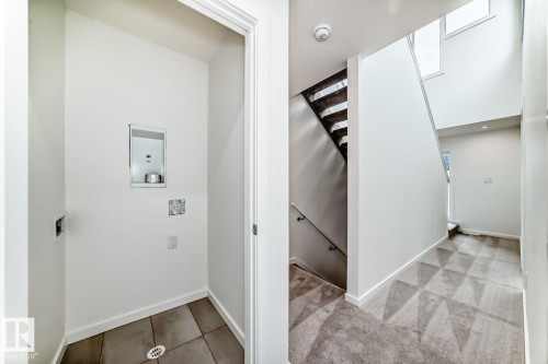 Dedicated laundry area with tile flooring and utility hookups - #67 5 Rondeau Dr, St. Albert, AB - Indoor Photo Showing Other Room