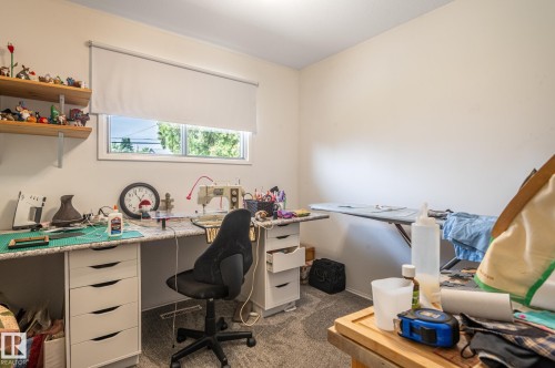 Room featuring light gray wall paint, a horizontal window with a white roller shade, gray textured carpeting, and recessed ceiling lighting - 13816 62 Street, Edmonton, AB 