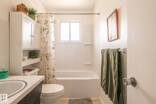 Bathroom featuring a built-in tub with a white surround - 13816 62 Street, Edmonton, AB 
