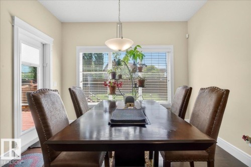 Dining space with a large window and white blinds - 1411 30 Avenue, Edmonton, AB 