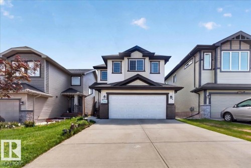 Two-story residence featuring light-colored siding with dark trim accents - 1411 30 Avenue, Edmonton, AB 