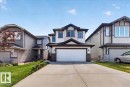 Two-story residence featuring light-colored siding with dark trim accents - 1411 30 Avenue, Edmonton, AB 