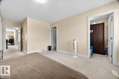 Cream-toned walls with white trim and light carpeting throughout - 1411 30 Avenue, Edmonton, AB 