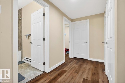 Wood-finish flooring throughout the hallway - 1411 30 Avenue, Edmonton, AB 