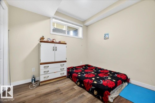 Room with light beige walls, wood-finish flooring, and white trim - 1411 30 Avenue, Edmonton, AB 