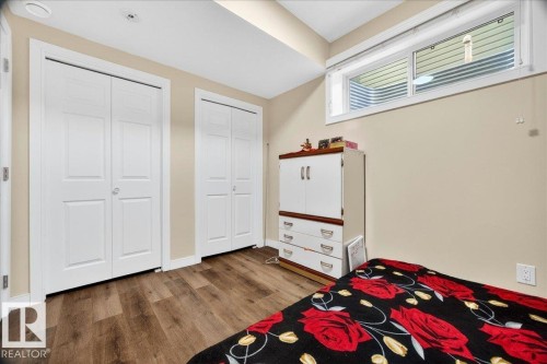Room featuring wood-finish flooring, neutral wall paint, and white trim - 1411 30 Avenue, Edmonton, AB 