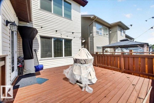 Spacious outdoor deck featuring wood-finish flooring and sturdy wood railings - 1411 30 Avenue, Edmonton, AB 